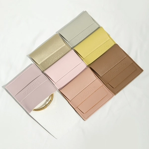 Flat lay of PU leather jewelry envelopes in multiple colors with embossed Vinknde logo
