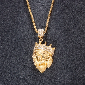 Close-up of golden lion head pendant with iced-out crown on twisted rope chain neckwear