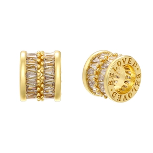 Detailed view of gold-plated cylinder bead with baguette zircon and BELOVED engraving