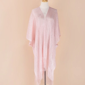 Detailed view of pink knitted shawl featuring elegant long tassels and shimmer fabric