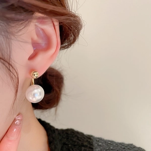 French style pearl pendant earrings with gold studs shown on a model in a side view