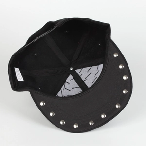 Detail of black snapback hat with silver metal studs and 100% polyester wash label