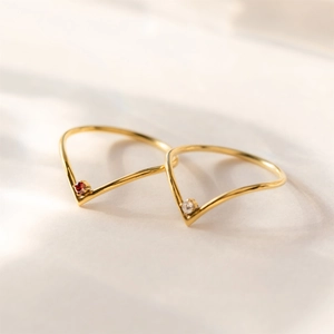 Golden titanium steel V-shape open rings featuring red and white birthstone settings