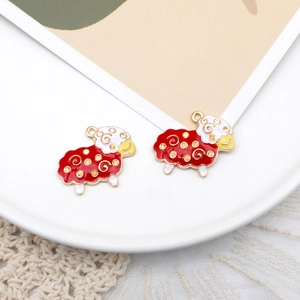 Detail of red and white cartoon sheep enamel pendants with golden metal trim for DIY jewelry