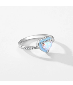 Macro shot of silver ring with heart-shaped rainbow opal stone and blue border accents