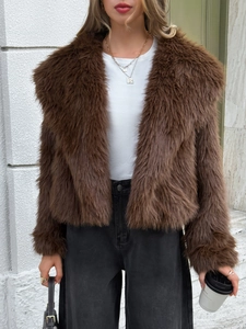 Street style view of women's brown faux fur coat paired with black trousers and handbag