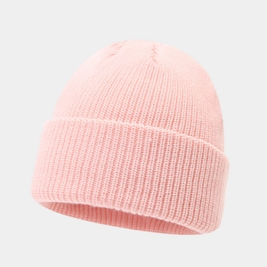 Close-up of pink knit beanie showing detailed vertical ribbed texture and folded cuff