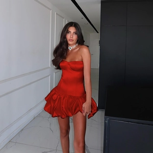 Detail of red strapless satin mini dress with ruched hem and flared A-line silhouette