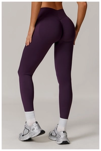 Detail view of high waist scrunch butt leggings in dark purple showing lifting effect