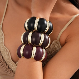 Detail of chunky acrylic link bracelet with black, purple, and gold metallic segments