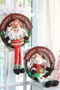 Detail of knitted Santa and Snowman hanging ornaments on natural rattan rings