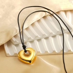 Minimalist gold heart-shaped hollow pendant necklace on black wax rope cord