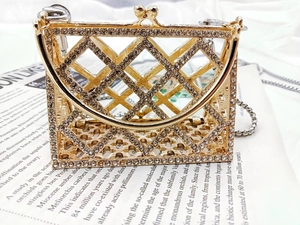 Close-up of gold rhinestone lattice evening bag with kiss-lock and chain strap