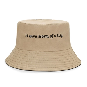 Close-up of khaki cotton bucket hat featuring precise black embroidered text and stitching