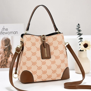 Women's khaki canvas bucket bag with geometric prints and brown leather trim