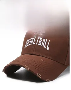 Detailed macro view of distressed brim and basketball embroidery on brown baseball cap