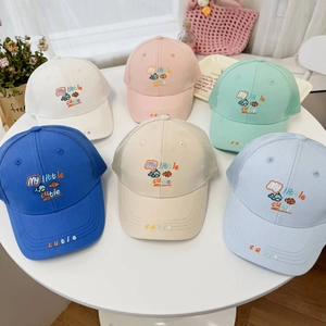 Detail showing various colors of breathable mesh baseball caps with fish embroidery