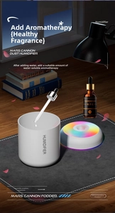 Detail of white mini humidifier showing RGB lighting with essential oil and dropper