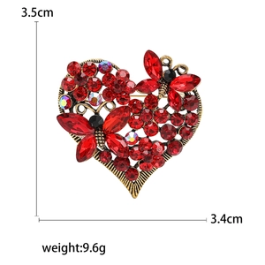 Luxurious vintage heart brooch with red rhinestones and golden butterfly accents