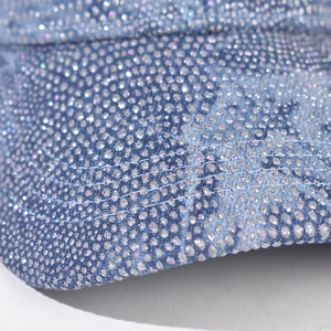 Macro shot of colorful rhinestones on deep blue denim baseball cap detail