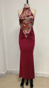 Detailed view of sequin floral embroidery and halter neck design on a burgundy gown