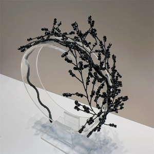 Detail of handcrafted black beaded branch headband with crystal hollow design for weddings