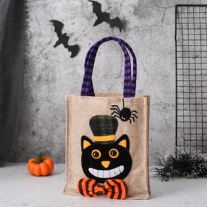 Halloween tote bag with black cat felt applique and striped handles for candy gift storage