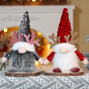 Detailed view of sequined Christmas gnomes with glowing antlers and plush beards