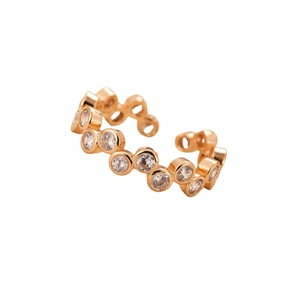 Elegant gold wave ring with sparkling cubic zirconia stones on white background