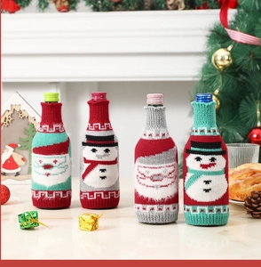 Knitted Christmas wine bottle covers featuring Santa and Snowman designs in festive colors