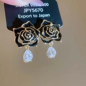 Macro shot of 18k gold plated S925 silver earrings with black rose and zircon water drop