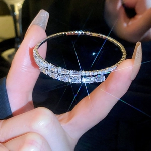 Close-up of sparkling silver bracelet with multi-row zircons reflecting bright starlight