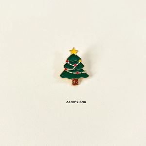 Detailed view of green enamel Christmas tree brooch with size dimensions 2.1cm x 2.6cm