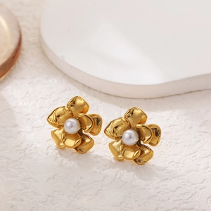 Macro detail of 18k gold sunflower earrings with pearls and textured petals