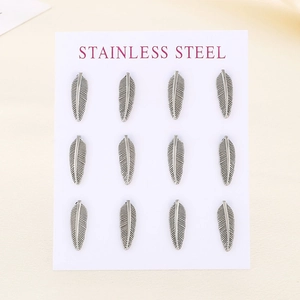 Detailed view of twelve silver feather charms on a stainless steel product card