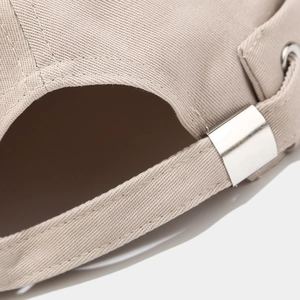 Beige cotton brimless docker cap featuring adjustable silver metal buckle and back strap