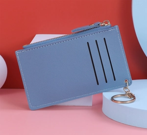 Slim blue leather card holder with vertical slots and gold zipper key ring