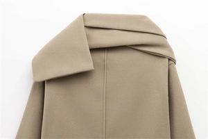 Detailed view of the camel wool jacket asymmetric collar with thick fabric texture