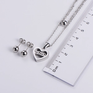 Silver hollow heart Mama necklace with ball stud earrings set shown with metric scale