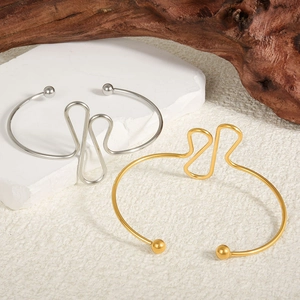 Adjustable 18k gold and silver wave-shaped stainless steel cuff bracelet with bead ends