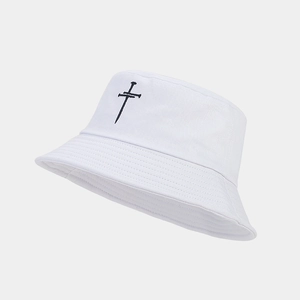 Close-up of black cross embroidery on a premium white cotton bucket hat with fine stitching