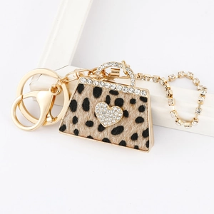 Leopard print handbag keychain with gold metal clasp and sparkling heart crystal accents