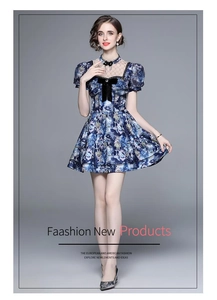 Detail of high-neck lace collar and black velvet bow on the blue printed dress