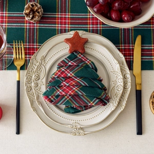 Christmas tree shaped napkins in red and green plaid for festive table decoration