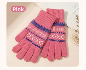 Close-up of pink knitted gloves with geometric jacquard pattern and elastic ribbed cuffs