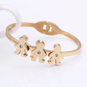 Gold open bangle featuring three family figurines with inlaid sparkling zircon stones