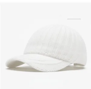 Detailed knit texture of an off-white wool baseball cap for autumn and winter warmth