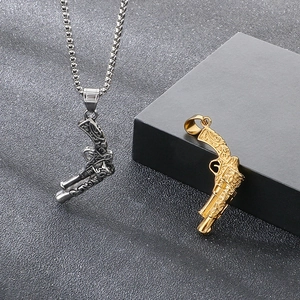 Detailed view of punk style pistol pendants in gold and silver with intricate textures