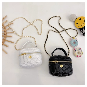 Close-up of quilted mini chain bags in black and white with cute floral accents