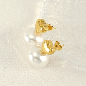 French vintage gold plated heart earrings with pearls on elegant white background